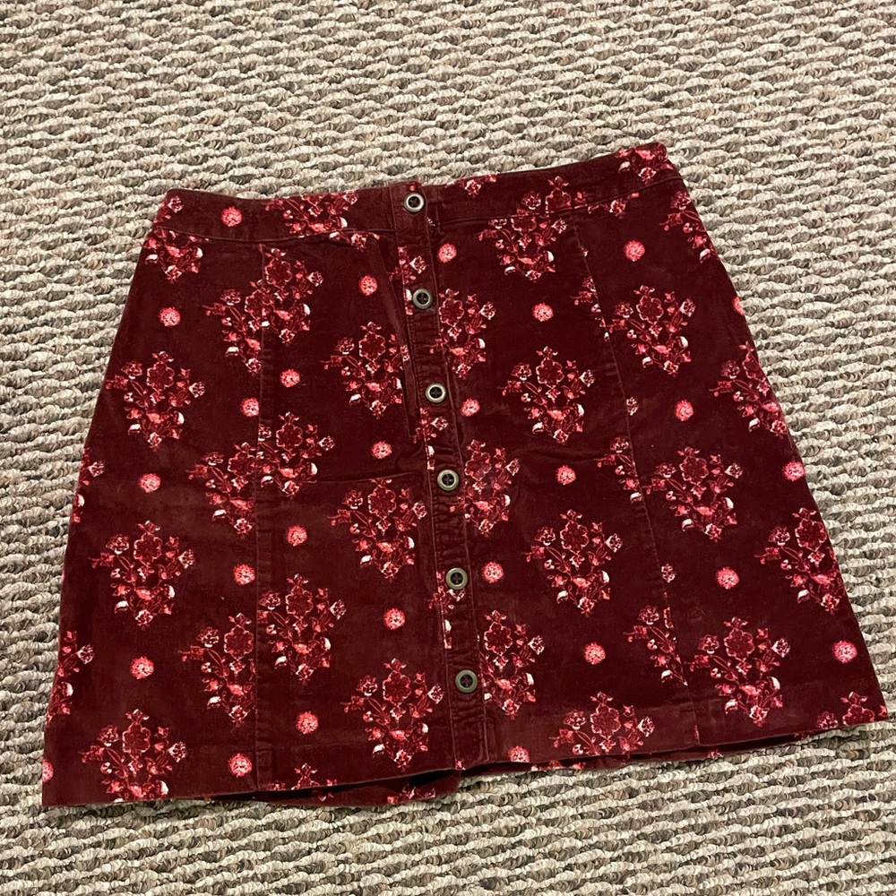 Velvety deep red print button skirt. Says size 7.